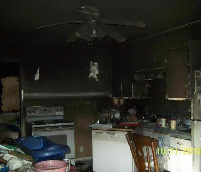 Kitchen with appliances and cabinets with fire and smoke damage