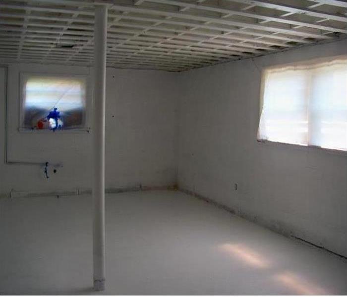 White basement with a support pole 