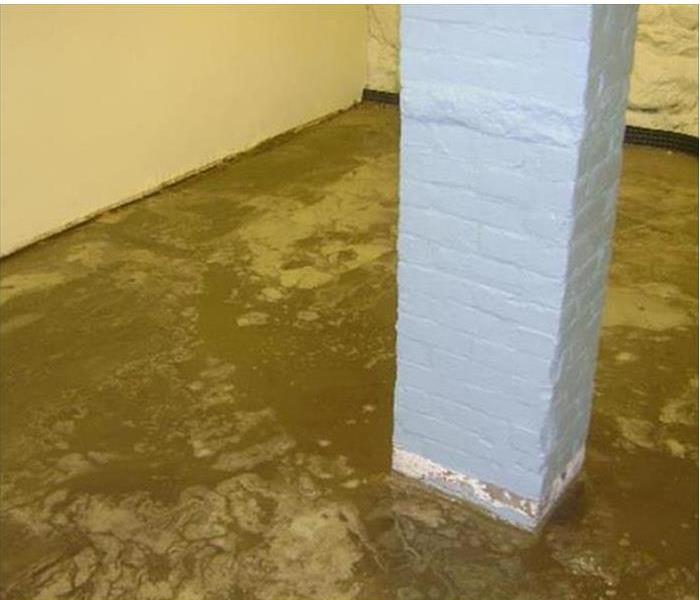 Basement with standing water around brick support