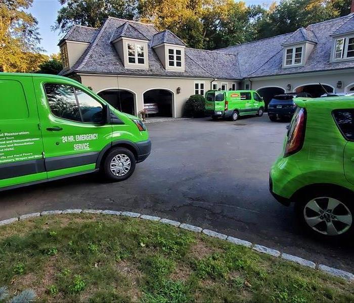 SERVPRO trucks & vans in front of a beautiful country club