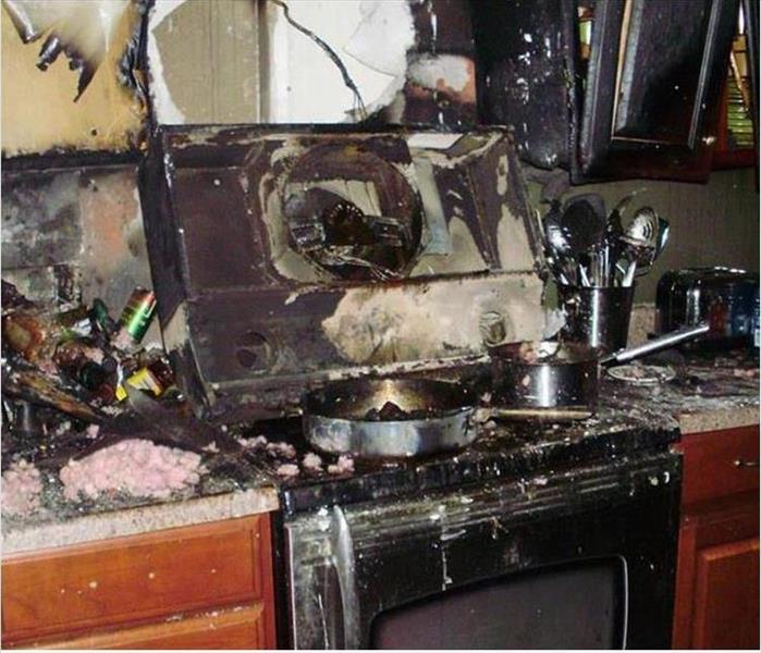 burnt and destroyed kitchen range and cabinets