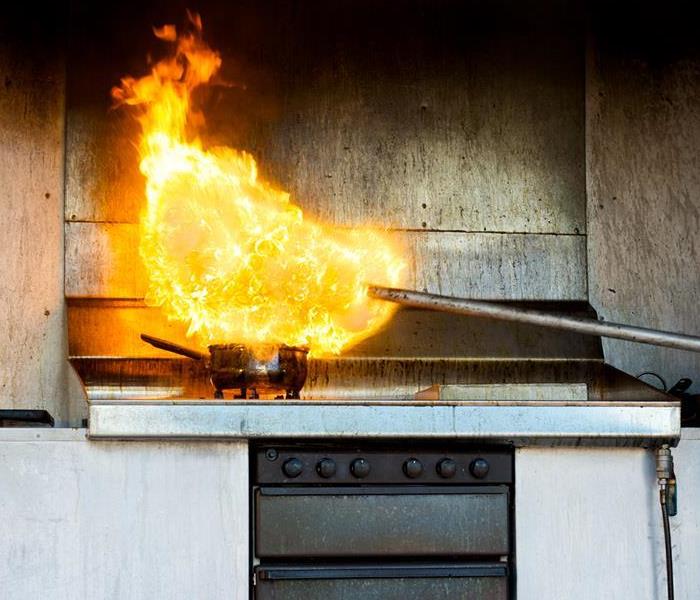 flames on a stove in a kitchen of a home 