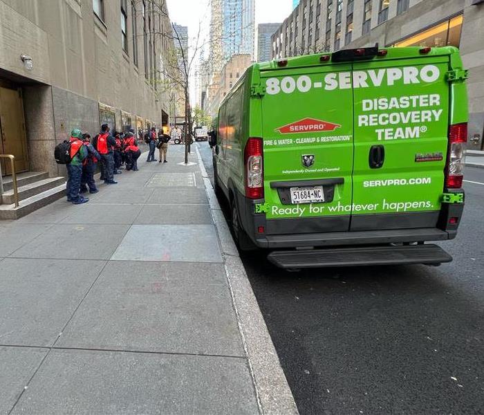 SERVPRO Trucks & Vans parked outside a building.
